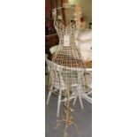 A gold painted wirework metal mannequin with crown finial,