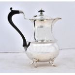 A silver four piece tea set, comprising; a teapot, a hot water jug,