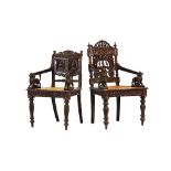 A late 19th century Burmese hardwood profusely carved open armchair, with rattan seat,