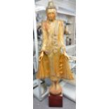 A tall Thai giltwood figure of Buddha, carved standing on a lotus with mirrored inlaid decoration,