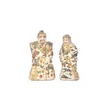 A pair of Japanese Satsuma figures of an elderly man and a woman, second half 19th century,