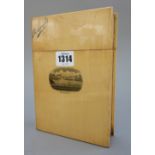 A Mauchline ware photograph album shaped as a book, printed with a coastal scene from 'Barmouth',