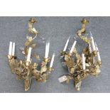 A pair of modern nine branch gilt metal wall lights, each cast as an arrangement of flowers,