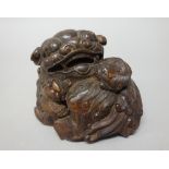 A Chinese bamboo group of a lion dog with two cubs, 10cm. high.