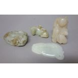 A group of four Chinese jade carvings, 19th/20th century, of various tones,