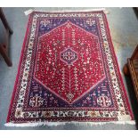 Two modern Ghasghai rugs, each with madder field, indigo spandrels,