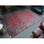 An Esfahan carpet, Persian, the madder field with a lobed indigo medallion, pale indigo spandrels,