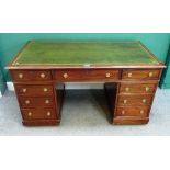 An early 20th century mahogany pedestal desk, with nine drawers about the knee, on a plinth base,