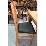 A set of six 20th century oak stick back dining chairs, with black leather seats, (6).