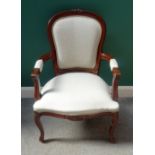 A Louis XV style mahogany framed open armchair, with serpentine seat on scroll supports,