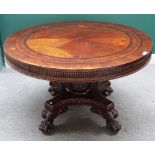 An early 19th century figured oak marquetry inlaid circular centre table,