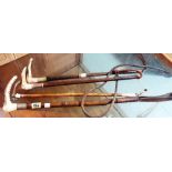 A group of four early 20th century riding crops, two with silver mounts,