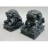 A pair of Chinese green hardstone carved dogs of Fo, each on a rectangular plinth, 11.5cm wide, (2).