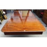 An early Victorian mahogany extending dining table, on turned and reeded supports,