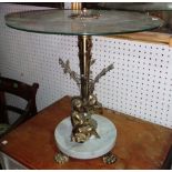 A 20th century glass and brass coffee table, the base formed as two cherubs, on claw feet,