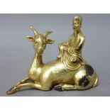 A Chinese gilt-bronze group of Shou Lao seated on the back of a recumbent deer, 10.5cm. high.