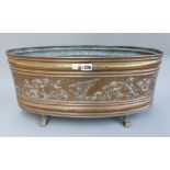 A Victorian oval copper jardiniere, embossed with a band of allegorical cherubs, with a tin liner,