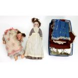 A Victorian dressed doll, the bisque hea