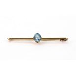 A gold and aquamarine bar brooch, centre