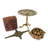 A brass trivet in the form of a miniatur