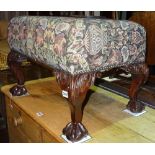 A George II style mahogany framed footstool on ball and claw feet, 61cm wide x 42cm high.