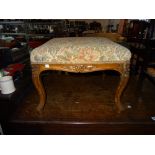An early 20th century walnut square footstool on carved cabriole supports, 50cm wide x 38cm high.