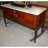 An Edwardian mahogany side cupboard with marble top on square tapering supports,