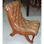 A 20th century mahogany Regency style low back button upholstered chair.