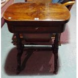 A Victorian walnut games table with single drawer and carved supports.