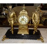 A 20th century spelter mantel clock flanked by two figures on black metal plinth base, 1 x key,