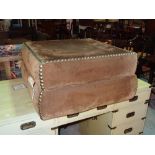 A 20th century metal studded brown suede square footstool, 63cm wide x 25cm high.