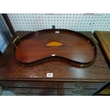 An Edwardian kidney shaped mahogany tray with galleried top with brass handles, 56cm wide.