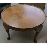 A reproduction shaped circular walnut coffee table with quarter veneered top, 60cm diameter.
