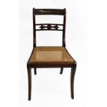A Regency rosewood cut brass inlaid and strung dining chair, with cane seat.