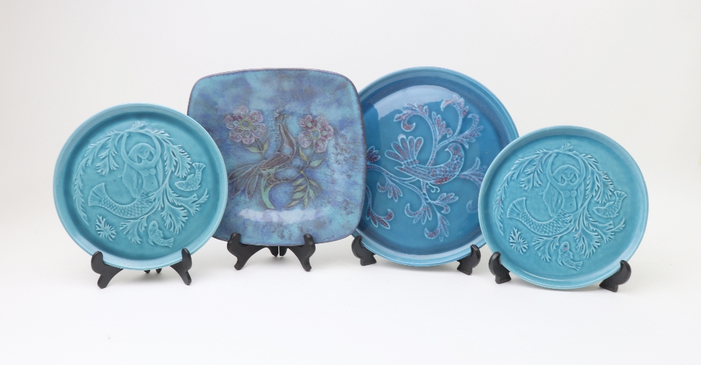 A pair of continental turquoise glazed plates, decorated with a mermaid and fish, 20cm diameter,