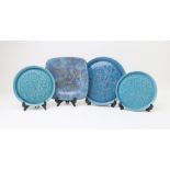 A pair of continental turquoise glazed plates, decorated with a mermaid and fish, 20cm diameter,