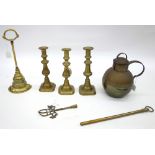 A Victorian brass door porter, 34cm high, a pair of brass candlesticks, another,