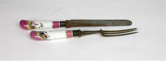 A German porcelain pistol handled knife and fork, circa 1760,