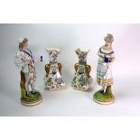 A pair of late 19th century French painted bisque figures of a young lady holding a stein and the