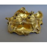A French rococo style ormolu encrier, 19th century, with twin inkwells and pierced hinged lids, 18.