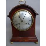 An Edwardian mahogany arched top mantel clock,