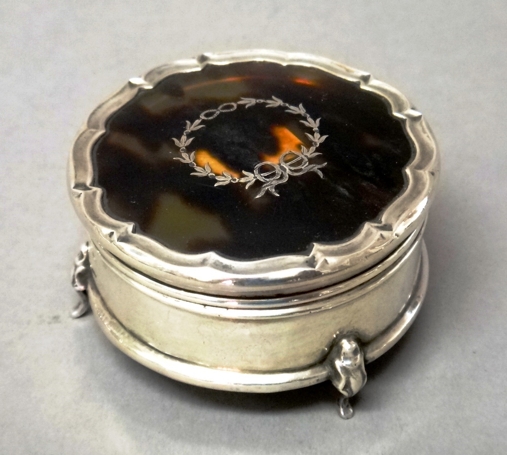 A silver and tortoiseshell lidded shaped circular trinket box,