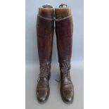 A pair of early 20th century gentleman's leather riding boots with wooden lasts detailed 'Maxwell