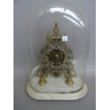 A Victorian brass skeleton clock with single fusee movement on a shaped marble base with glass dome,