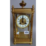 A regency style brass, four glass mantel clock, circa.