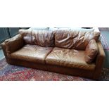 A 20th century brown leather upholstered square back sofa on block supports, 224cm wide x 71cm high.