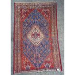 A North West Persian rug, the central white medallion with stepped Kazak style motif,