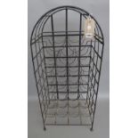 A modern black painted wrought iron wine rack of domed open cage form with space for 25 bottles