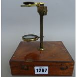 A 19th century mahogany cased travelling microscope, with screw attachment to the hinged lid,