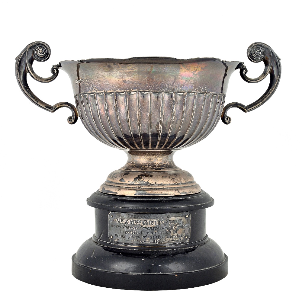 A silver twin handled trophy bowl, having a shaped rim,